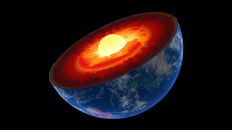 An illustration of the Earth sliced in half to expose a glowing inner core